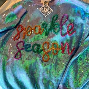 New with tags, queen of sparkle season sweater. It’s a size large.